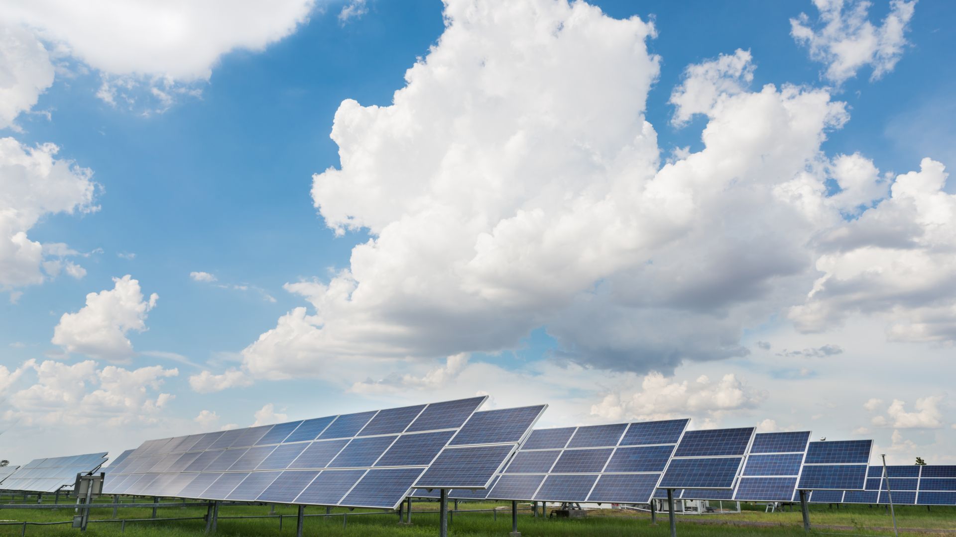 solar array with big puffy clouds